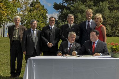 Multiculturalism Minister Jason Kenney sits beside Klimkowski at an official announcement for the memorial (Image courtesy: Citizenship and Immigration Canada)  