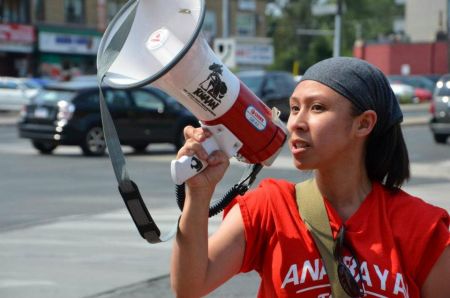 Rhea Gamana of Anakbayan Toronto leads the rally.