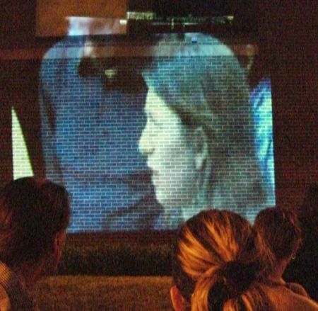July 7th: Watching a video on the police station wall during a vigil about sexual violence from police