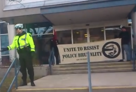 The People's report is delivered to the police on the international day against police brutality. (screenshot from video by the Kitchener Independent) 