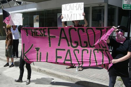 Carrying a banner reading "These faggots kill fascists" anti-fascists send a different message in front of homophobic signs held by bigots at the London, Ontario pride parade on July 25, 2010. Photo: Toban Black 