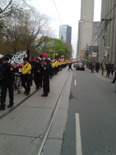 Heavy police presence alongisde the march.  Photo by Tyler Ledger (@mrdreamwood).