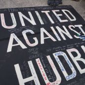 Attendees signed a banner in solidarity with communities across the Americas harmed by Hudbay Minerals. Photo by Kim Abis.