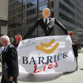 Giant Peter Munk Puppet with a Pinochio nose and blood on his hands is used to educate shareholders about how they can #suebarrick