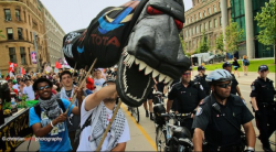 Activists with a tar sands pipeline dragon during the environmental justice day of action at the G20 protests in 2010. (photo: Christian Peña)