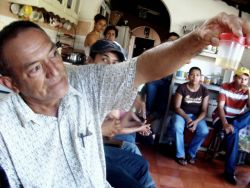 Nov. 29, 2009 - At a community meeting in Jutiapa, people give detailed accounts of the repression they have faced to members of FIAN human rights workers.  One man holds up a jar containing a piece of the skull of a local who was shot in the head by police a few months earlier.  