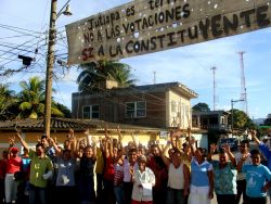 Nov. 29, 2009 - In the southern town of Jutiapa, the community has refused to be intimidated by the military and police.  Despite kidnappings and detentions, beating and death threats, and a ceaseless campaign of terror, they hang a banner on the main road through town declaring themselves against the coup and the elections.  They pose for a photo, cheering beneath their banner, knowing that police are stationed just a few blocks away.
