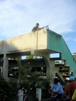 Nov. 29, 2009 - Just blocks away from the banner rejecting the elections and the coup, military and police guard a polling station.  Ballot boxes have been set up at this local school, which looks more like a military facility, as troops with M-16s surround anyone who enters the school grounds.