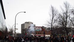 flashbangs  and tear gas are used by the SPVM with a helicopter overhead. contre sommet manif feb/2012