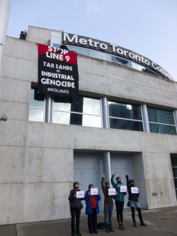 Banner drop in front the of Metro Convention Centre, where the NEB hearings are taking place this week in Toronto. Photo Credit: Michael Toledano