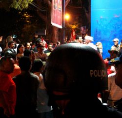 Nov. 30, 2009 - Demonstrators demand to see President Zelaya, in the shadow of the police.