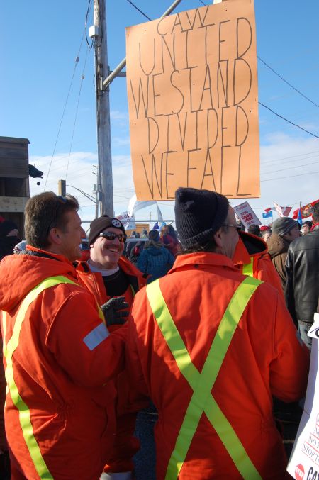  Locked out workers on the picket line share a laugh during a mass picket outside the Electro-Motive Diesel plant in London, Ont. on Jan. 21  Photo: Mick Sweetman 
