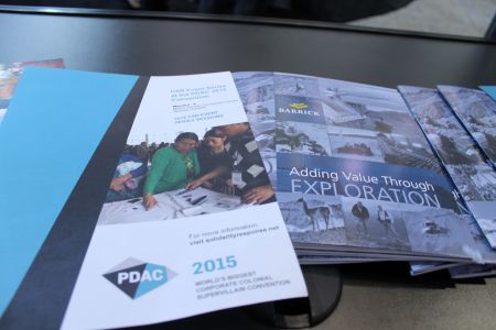 The spoofed pamphlets sit next to mining industry reports inside PDAC's trade show area.