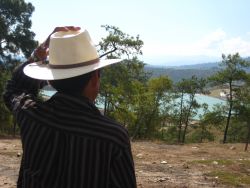 A mayan man looks on towards the tailings pond.  [Guatemala]